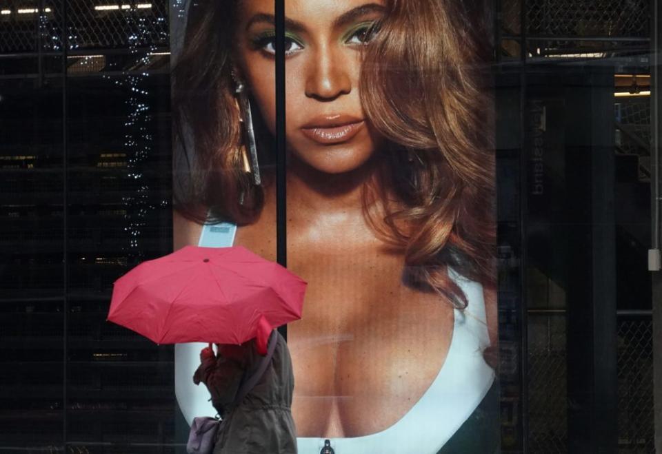 A person walks by a window advertisment at Adidas Fifth Avenue Flagship store for Beyonce's second Ivy Park x Adidas apparel collection in New York November 1, 2020. (Photo by TIMOTHY A. CLARY / AFP) (Photo by TIMOTHY A. CLARY/AFP via Getty Images)