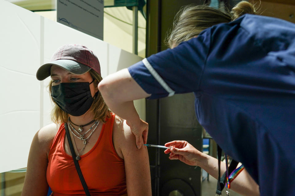 NEWCASTLE UPON TYNE, ENGLAND - JUNE 22: Emily Stone-Wigg, 22 from Derbyshire receives the Pfizer-BioNTech COVID-19 Vaccine at a new ‘Pop Up’ vaccination service on June 22, 2021 in Newcastle upon Tyne, England. The new ‘Pop Up’ vaccination service based at Times Square in Newcastle will add an additional 2000 weekly appointments, initially opening four days a week and offering up to 500 vaccinations a day, starting on Tuesday 22nd June. Vaccinations will be available from 8.30am until 7pm on a first come, first serve basis, requiring patients to collect a ticket and queue. The large vaccination centre based inside the Centre for Life continues to vaccinate people who have booked through the National Booking Service and has increased its capacity to around 1500 people a day. (Photo by Ian Forsyth/Getty Images)