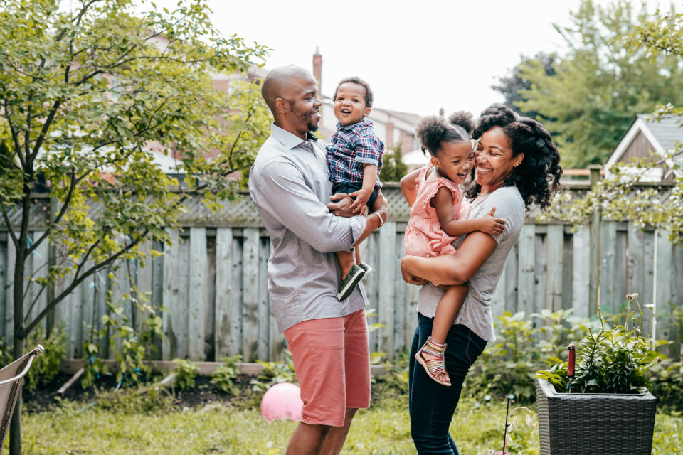 young couple with two kids in their backyard