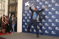 File - Ralph Fiennes dances during a photo call for 'A Bigger Splash' at the Venice Film Festival. The 77th Venice Film Festival will kick off on Wednesday, Sept. 2, 2020, but this year's edition will be unlike any others. Coronavirus restrictions will mean fewer Hollywood stars, no crowds interacting with actors and other virus safeguards will be deployed. (Photo by Joel Ryan/Invision/AP, File)