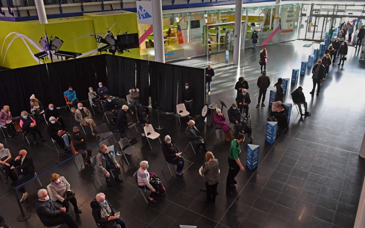 People wait to receive their Covid-19 vaccine at the Millennium Point centre in Birmingham, on Monday - Jacob King/POOL/EPA-EFE/Shutterstock