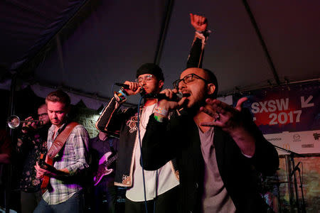 Kayem (C), who is Libyan-American, performs with Bassel and the Supernaturals, led by Bassel Almadani (R), who is first-generation Syrian American, at the ContraBand Showcase featuring artists representing countries included in U.S. President Donald Trump's executive order travel bans, at the South by Southwest (SXSW) Music Film Interactive Festival 2017 in Austin, Texas, U.S. March 18, 2017. REUTERS/Brian Snyder