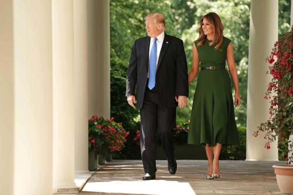 <p>This deep olive dress complete with her go-to Louboutin heels were worn by Melania during a prayer service in May 2019. </p>