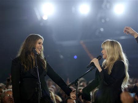 Stevie Nicks (R) and Hillary Scott of Lady Antebellum hold hands after performing "Golden" together at the 49th Annual Academy of Country Music Awards in Las Vegas, Nevada April 6, 2014. REUTERS/Robert Galbraith