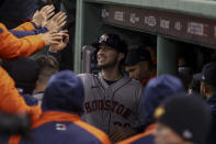 Houston Astros' Kyle Tucker celebrates in the dugout after his three-run home run against the Boston Red Sox during the fourth inning in Game 3 of baseball's American League Championship Series Monday, Oct. 18, 2021, in Boston. (AP Photo/Winslow Townson)