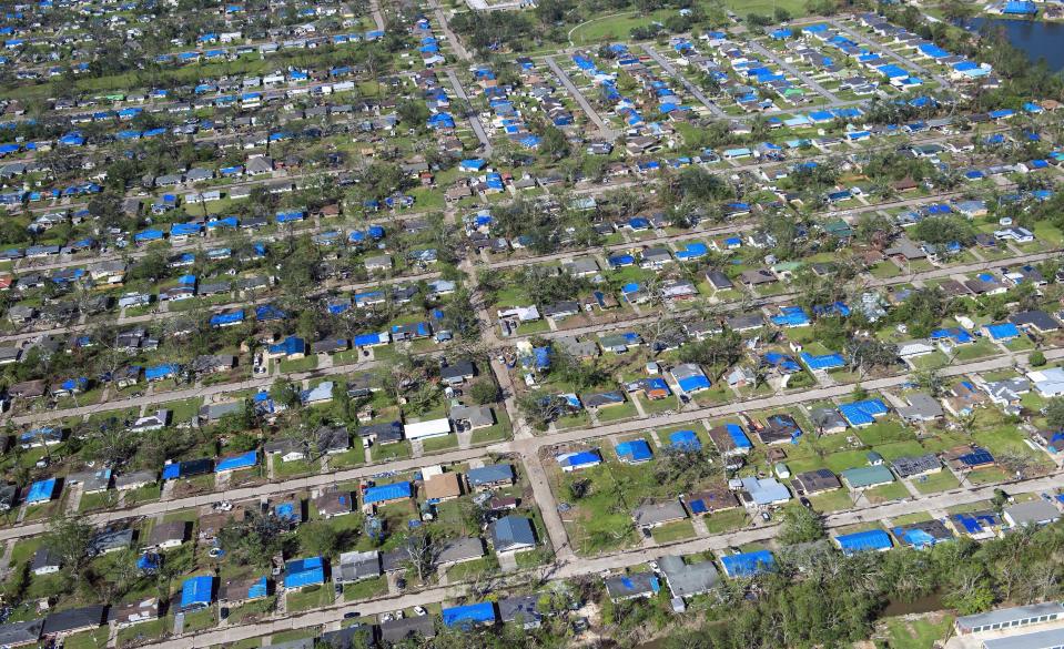 Blue tarps cover houses in the aftermath of Hurricane Delta, Saturday Oct. 10, 2020, in Lake Charles, La. (Bill Feig/The Advocate via AP, Pool)