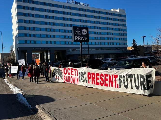 Indigenous education activists demonstrate their opposition Friday, Feb. 10, 2023, to proposed social studies outside the Rushmore Hotel in Rapid City.