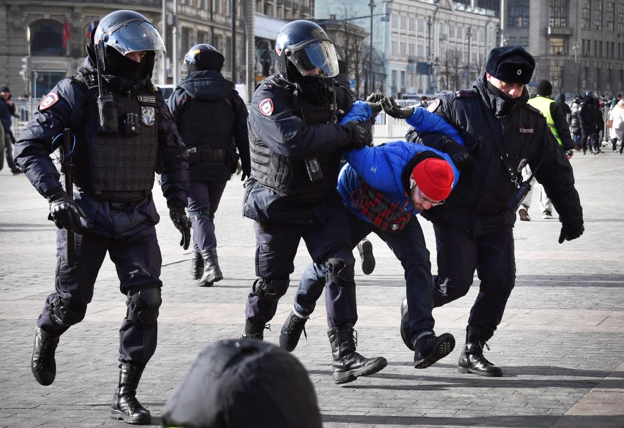 Russian police detain a man during a protest against Ukraine invasion