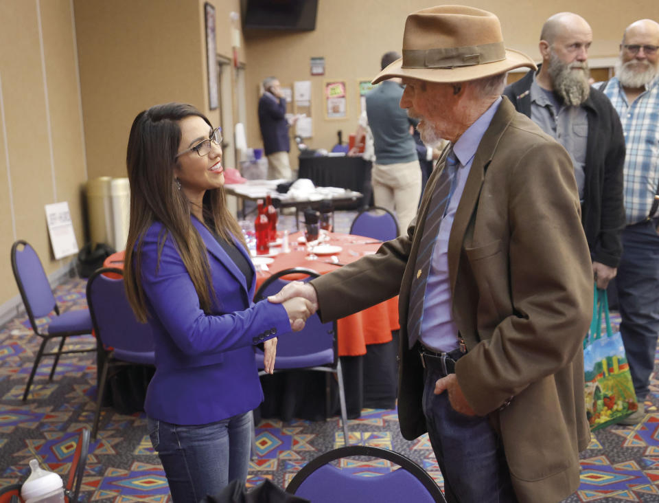 Rep. Lauren Boebert, R-Colo., talks with Jim Lynch, Saturday, Oct. 28, 2023, in Towaoc, Colo., before speaking at the Montezuma County Lincoln Day Dinner at the Ute Mountain Casino Hotel. (AP Photo/Jerry McBride)