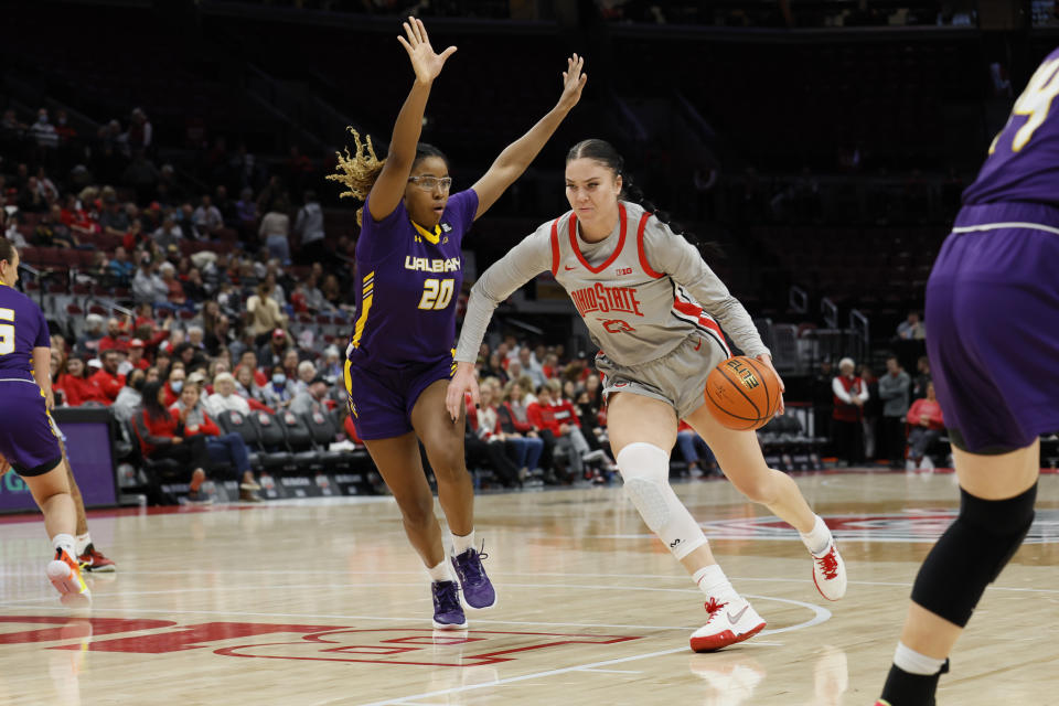 Ohio State's Rebeka Mikulasikova, right, drives to the basket against Albany's Kayla Cooper during the first half of an NCAA college basketball game on Friday, Dec. 16, 2022, in Columbus, Ohio. (AP Photo/Jay LaPrete)