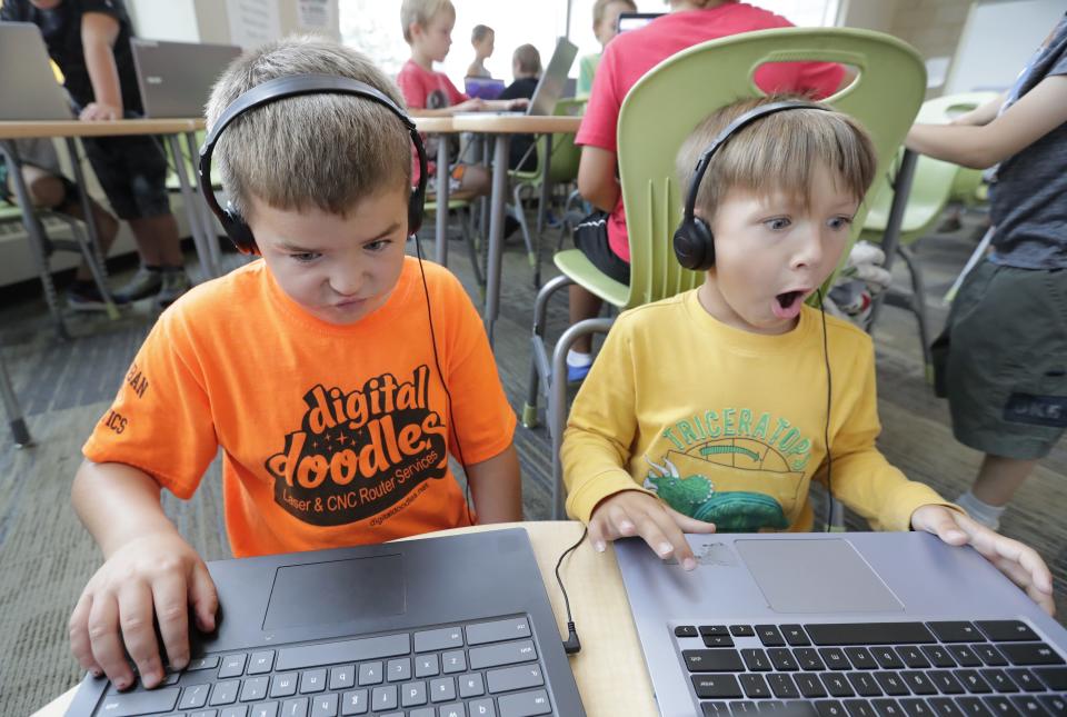 Cole Belonger, left, and Adrian Hancock play videos that foster a sense of community within the online platform in the Plexus Technology Center at the Boys & Girls Club of Menasha Friday, August 11, 2023, in Menasha, Wis.