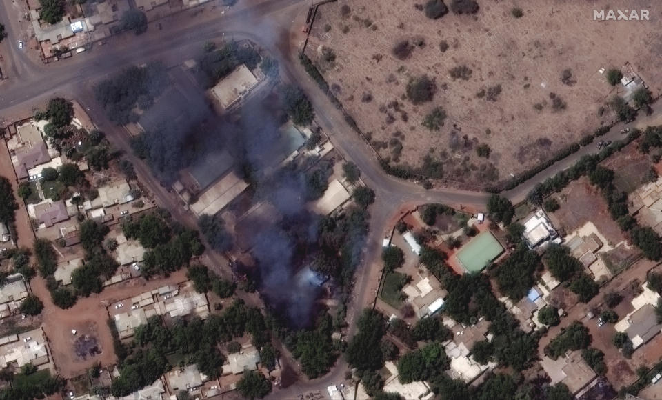 This satellite image provided by Maxar Technologies shows burning buildings and military patrol northeast of Khartoum International Airport, Sudan, Monday April 17, 2023. The Sudanese military and a powerful paramilitary group are battling for control of the chaos-stricken nation for a third day. (Satellite image ©2023 Maxar Technologies via AP)