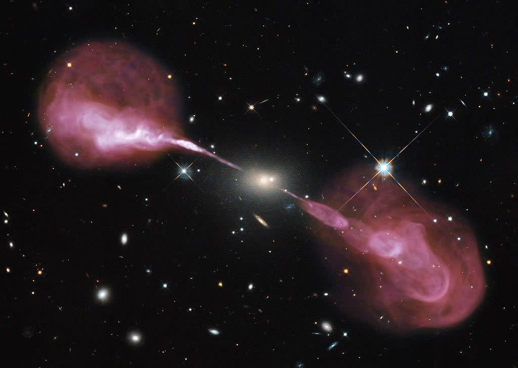 A radio image shows energy streaming from the heart of radio galaxy Hercules A (Nasa/ESA)