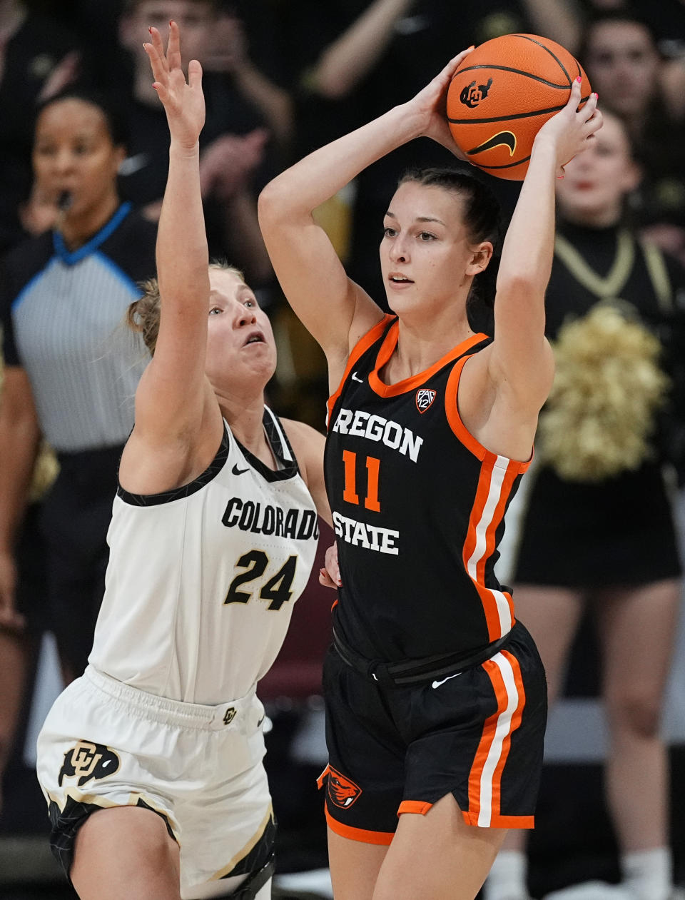 Oregon State guard AJ Marotte, right, looks to pass the ball as Colorado guard Maddie Nolan, left, defends in the second half of an NCAA college basketball game Sunday, Feb. 11, 2024, in Boulder, Colo. (AP Photo/David Zalubowski)
