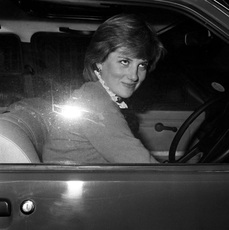 Lady Diana smiling at photographers after stalling her new car in in 1980 – amid mounting speculation over her relationship with the Prince of Wales (PA) (PA Archive)