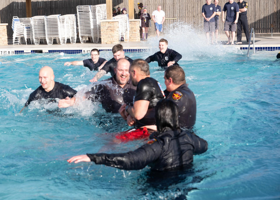 Members of the Amarillo Police Department frolic in the cold water at the Polar Plunge Saturday morning at the Amarillo Town Club.