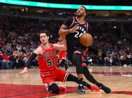 Mar 30, 2019; Chicago, IL, USA; Toronto Raptors forward Norman Powell (24) dribbles the ball past Chicago Bulls guard Ryan Arcidiacono (51) during the second half at the United Center. Mandatory Credit: Mike DiNovo-USA TODAY Sports