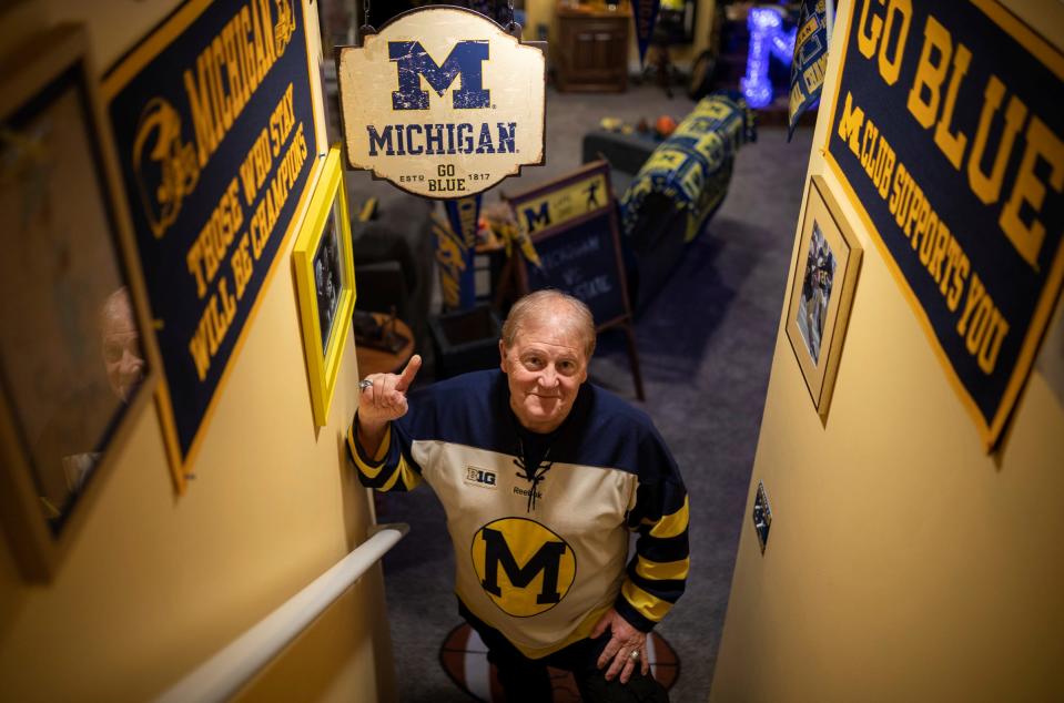 University of Michigan superfan and retired teacher Kenn Domerese, 73, stands on the basement stairs inside his home in Fenton on Saturday, Jan. 06, 2024. Domerese has hundreds of pieces of University of Michigan memorabilia.
