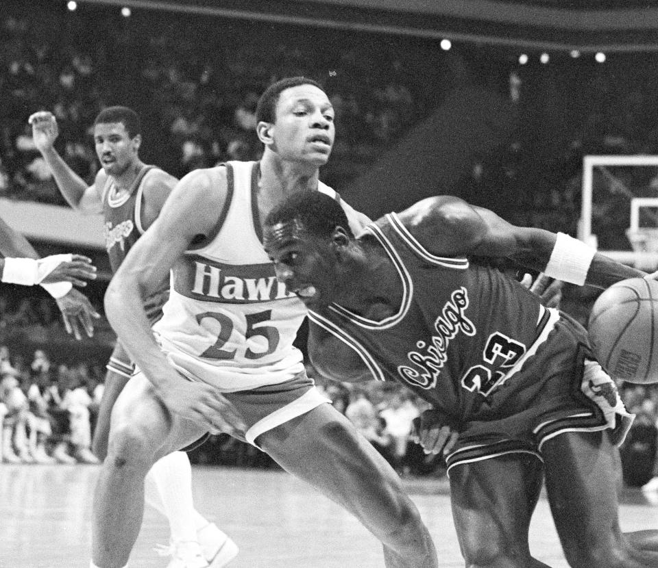 Chicago Bulls' Michael Jordan (23) drives past Atlanta Hawks' Glenn Rivers (25) during second period in their game at the Atlanta Omni, Jan. 3, 1985. Atlanta won the game 121-107. (AP Photo/Joe Holloway Jr.)