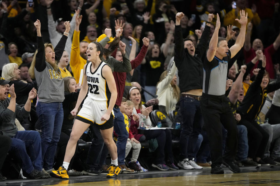 Iowa guard Caitlin Clark (22) reacts after breaking the NCAA women's career scoring record during the first half of the team's college basketball game against Michigan, Thursday, Feb. 15, 2024, in Iowa City, Iowa. (AP Photo/Matthew Putney)