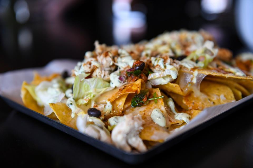 Main Street Pub management introduces Caribbean jerk nachos to the menu in Spartanburg, S.C., on Wednesday, April 10, 2024.