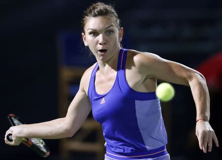 Simona Halep of Romania returns the ball to Caroline Wozniacki of Denmark during their women's singles tennis semi-final match at the WTA Dubai Tennis Championships February 20, 2015. REUTERS/Ahmed Jadallah