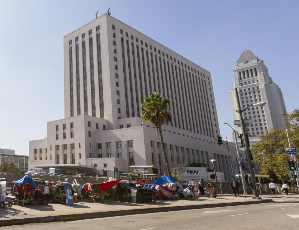 Homeless camp in tents downtown Los Angeles Tuesday, Sept. 17, 2019. Los Angeles Mayor Eric Garcetti says he hopes President Donald Trump will work with the city to end homelessness as the president visits California for a series of fundraisers. Garcetti says the federal government could aid Los Angeles with surplus property or money to create additional shelters. Garcetti says he has not been invited to meet with the president. in Los Angeles (AP Photo/Damian Dovarganes)