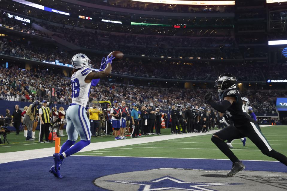Dallas Cowboys' CeeDee Lamb catches a touchdown pass in front of Philadelphia Eagles' James Bradberry during the second half of an NFL football game Saturday, Dec. 24, 2022, in Arlington, Texas. (AP Photo/Michael Ainsworth)