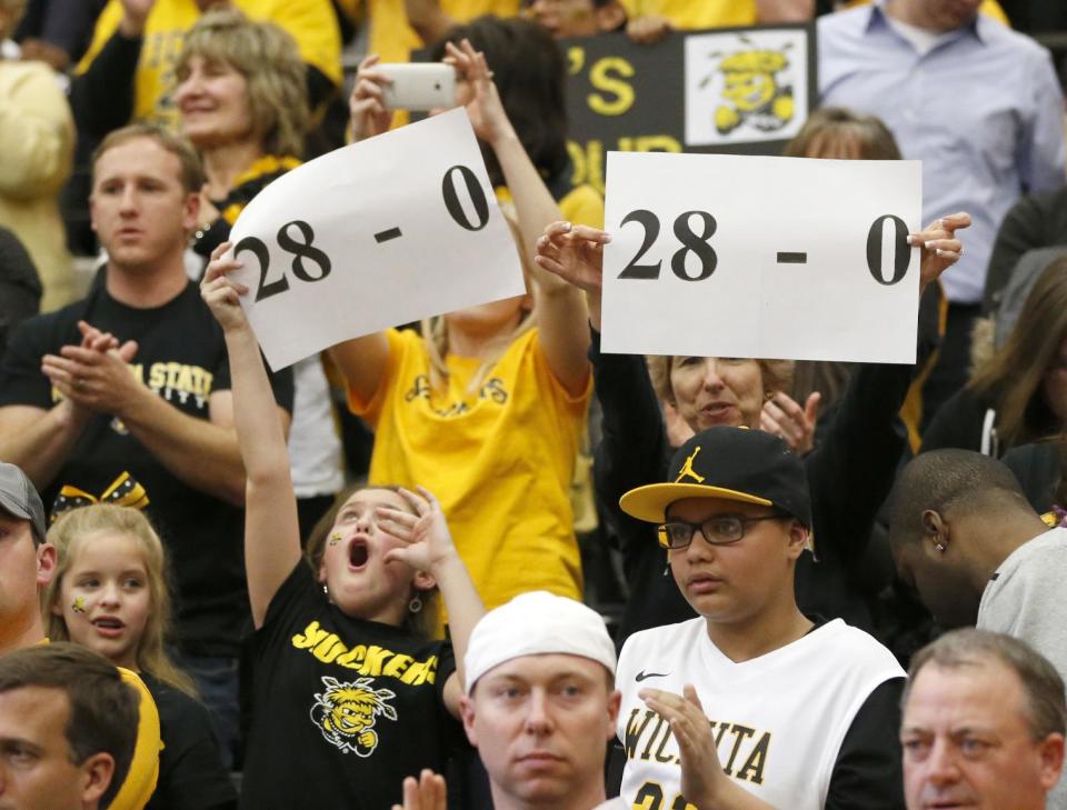 Wichita State fans celebrate their team 88-74 win over Loyola of Chicago during the second half of an NCAA college basketball game Wednesday, Feb. 19, 2014, in Chicago. (AP Photo/Charles Rex Arbogast)