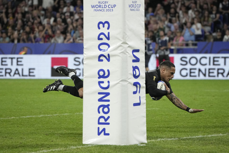 New Zealand's Aaron Smith scores a try during the Rugby World Cup Pool A match between New Zealand and Italy at the OL Stadium in Lyon, France, Friday, Sept. 29, 2023. (AP Photo/Laurent Cipriani)