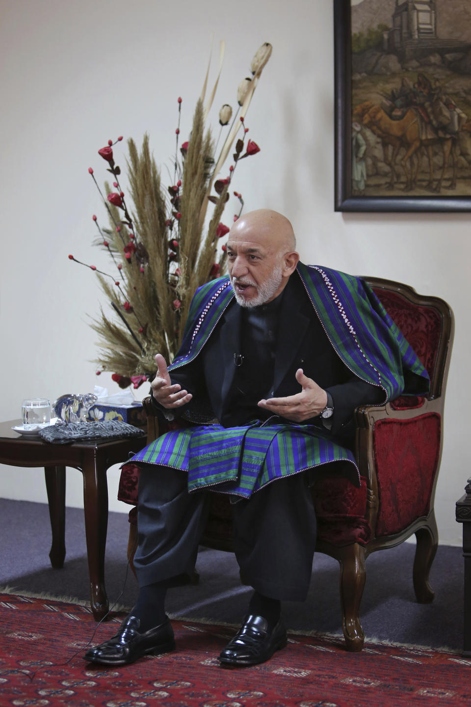 Former Afghan President Hamid Karzai speaks during an interview with The Associated Press, in Kabul, Afghanistan, Tuesday, Dec. 10, 2019. Karzai, whose final years in power were characterized by a cantankerous relationship with the United States, said on Tuesday that Washington used blackmail and corruption to manipulate his officials, undermine his government and foment violence among the country's many factions. (AP Photo/Altaf Qadri)