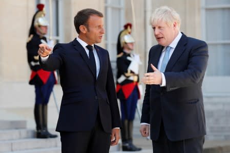 French President Emmanuel Macron welcomes British Prime Minister Boris Johnson before a meeting on Brexit at the Elysee Palace in Paris