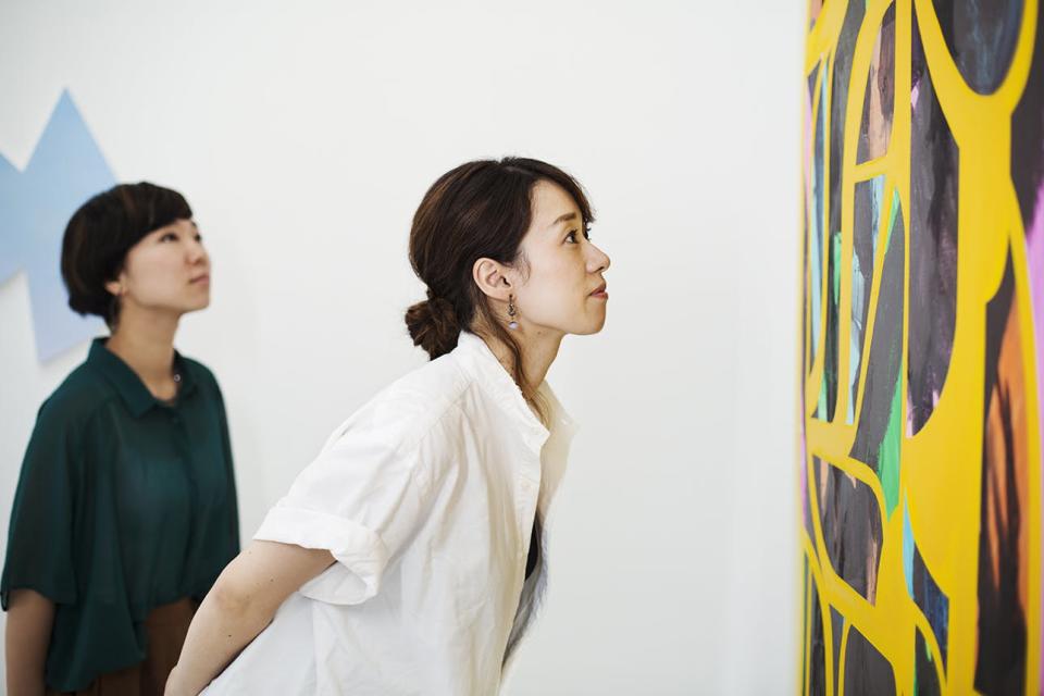 Two women at an art gallery