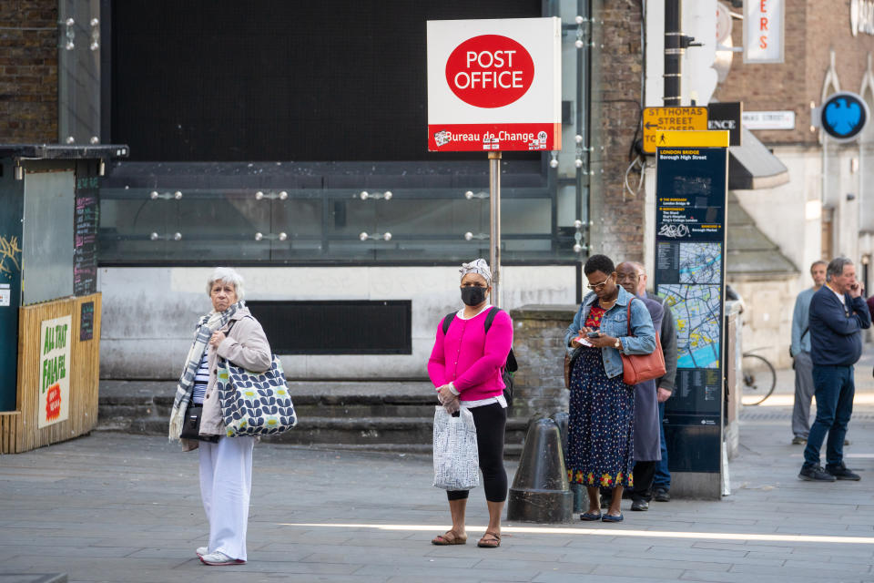 People queue for a branch of the Post Office near London Bridge, London, after the introduction of measures to bring the country out of lockdown. (Photo by Dominic Lipinski/PA Images via Getty Images)