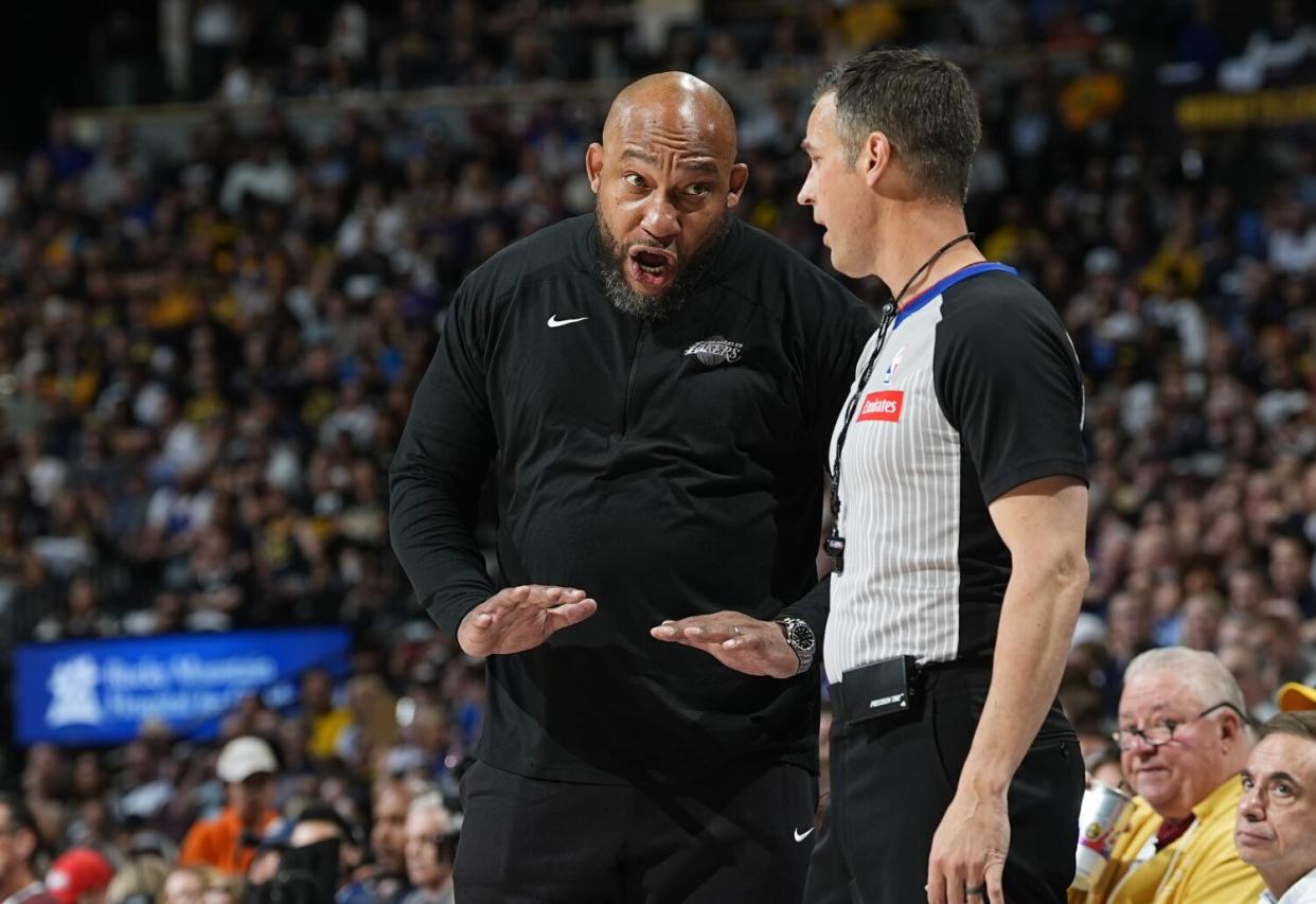 Lakers coach Darvin Ham, left, argues for a call with referee Kevin Scott during the first half of Game 5.
