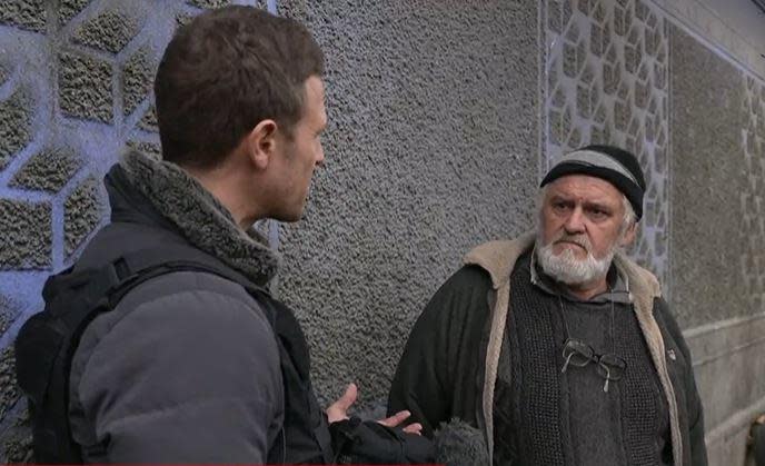 CBS News' Chris Livesay, left, speaks with Oleksander outside the Kherson resident's mother's home in the southern Ukrainian city, just several days after Russian forces retreated from it.  / Credit: CBS News