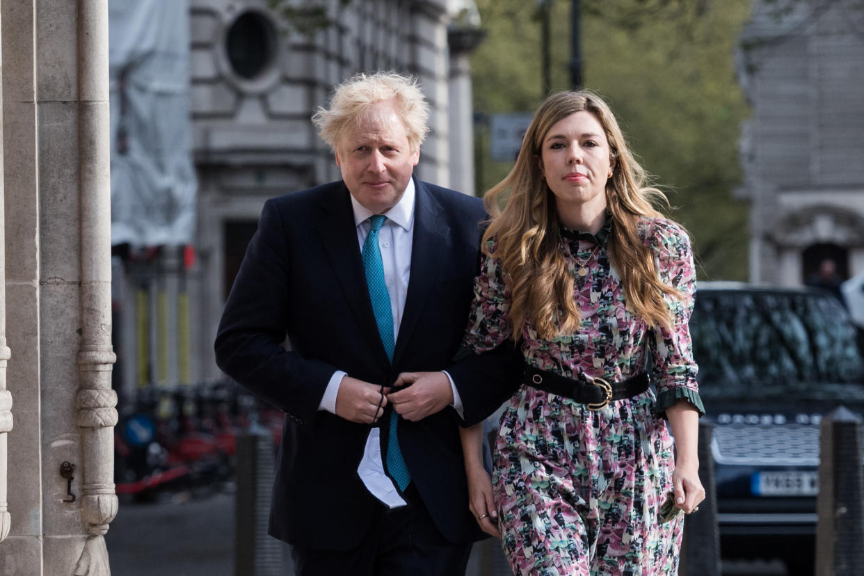 LONDON, UNITED KINGDOM - MAY 06, 2021: British Prime Minister Boris Johnson and his fiancee Carrie Symonds walk to a polling station at Methodist Central Hall in London to cast their votes in the local elections, on 06 May, 2021 in London, England. Millions of voters across England head to the polls today to decide on thousands of council seats, choose 13 mayors, including London, with many of the elections postponed from last year due to 
the Covid-19 pandemic. (Photo credit should read Wiktor Szymanowicz/Barcroft Media via Getty Images)