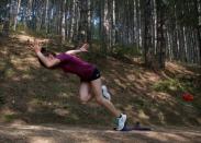 Kosovo's 400 metres runner Vijona Kryeziu runs in the woods of the village Rogane in Kamenica, Kosovo, July 30, 2016. Kryeziu trains in the woods because there was no athletics stadium nearby. The Rio Games will be the first to host athletes competing under the flag of Kosovo. REUTERS/Hazir Reka