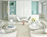 <p>For a <a href="https://www.elledecor.com/design-decorate/house-interiors/a28816068/lee-mindel-miami-beach-house/" rel="nofollow noopener" target="_blank" data-ylk="slk:Miami Beach escape;elm:context_link;itc:0;sec:content-canvas" class="link ">Miami Beach escape</a>, designer Lee F. Mindel settled on a seamless blend of modern touches and pop sensibilities—the perfect mix for a couple and their four children. The living room is outfitted with custom sofas in a Bergamo fabric, Marc Newson tables from Cappellini, and a 1980s side table by Vistosi. Mindel enhanced the design scheme with the eye-catching Face à Face bench by Pierre Paulin through Ralph Pucci, and a custom rug by V’Soske. The bookshelf, which is also custom, features a collection of vases and ceramics from Luminaire and Jalan Jalan. </p>