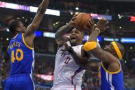 Los Angeles Clippers forward Glen Davis, center, goes up for a shot as Golden State Warriors forward Harrison Barnes, left, and center Jermaine O'Neal defends during the first half in Game 7 of an opening-round NBA basketball playoff series, Saturday, May 3, 2014, in Los Angeles. (AP Photo/Mark J. Terrill)