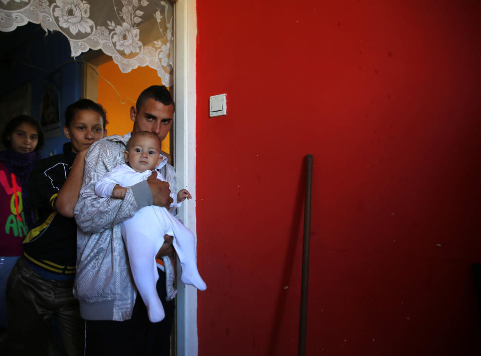 A Roma family stands in their apartment at the Avas apartment block in Miskolc