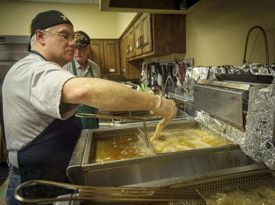 Rob McFarlane fries the fish to a golden perfection during a fish fry at Saints John and Paul Catholic Church in Altoona in 2015.