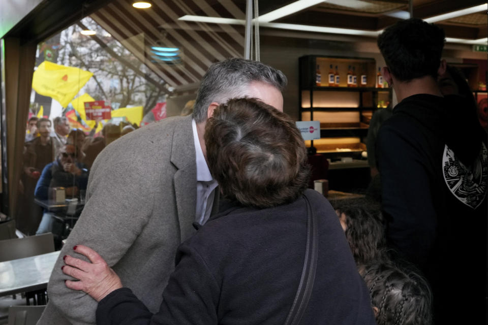 Socialist Party leader Pedro Nuno Santos, left, receives a kiss from a supporter while campaigning on the street in Setubal, south of Lisbon, March 5, 2024. Portugal will hold a general election on March 10. (AP Photo/Armando Franca)