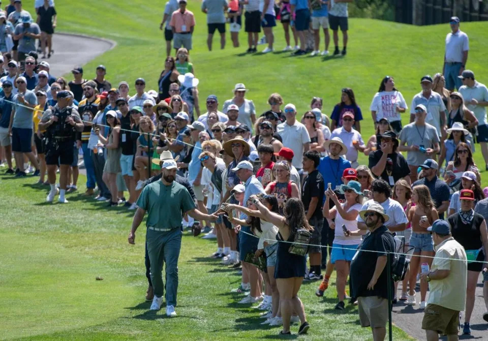 Kansas City Chiefs star Travis Kelce reaches out to fans as he makes his way up the fairway in the first round of the American Century celebrity golf championship on Friday, July 12, 2024, in Stateline, Nev.