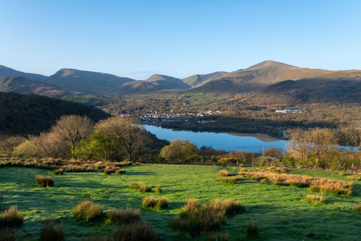 Llyn Padarn and Llanberis from a hillside in Snowdonia national park, North Wales. A beautiful spring morning in the mountains.