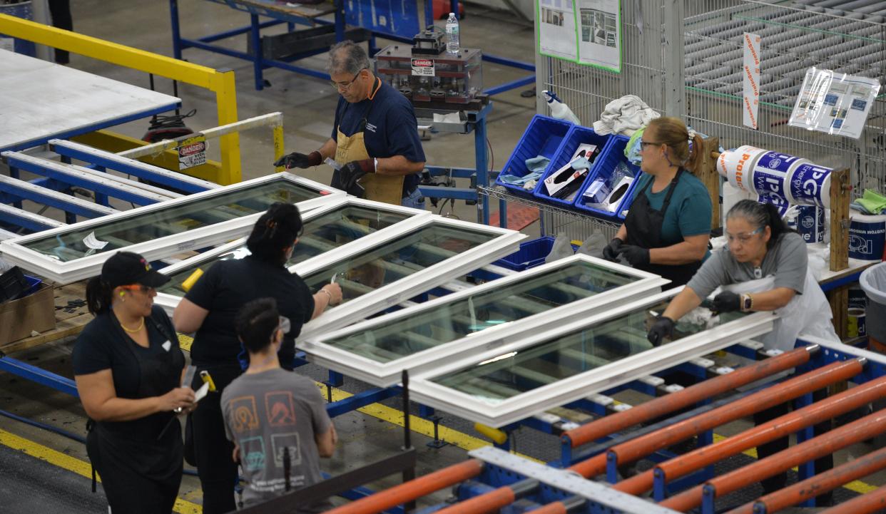 PGT employees assemble windows on the production floor of the manufacturing facility in Venice on Nov. 16, 2023.