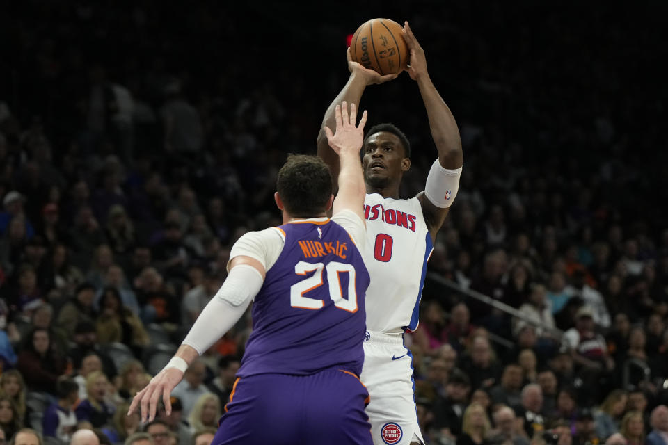 Detroit Pistons center Jalen Duren (0) shoots over Phoenix Suns center Jusuf Nurkic during the first half of an NBA basketball game, Wednesday, Feb. 14, 2024, in Phoenix. (AP Photo/Rick Scuteri)