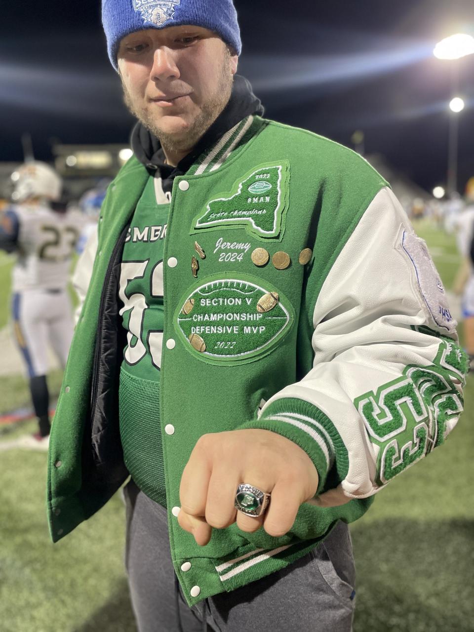 Pembroke senior JJ Gabbey shows off his 2022 football state championship ring while attending the Eddie Meath All-Star Game on Monday, Nov. 20, 2023 at the University of Rochester.