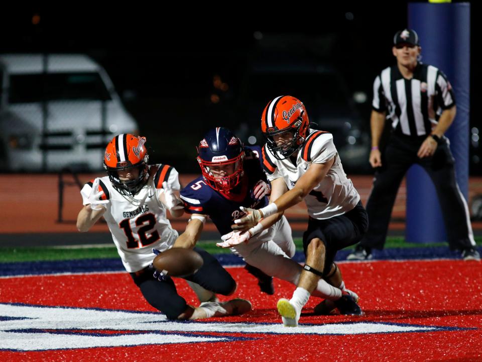 Ridgewood's Preston Ator, left, and teammate Jace McQueen go after a lose ball in the end zone with Indian Valley's Tanyon McComb on Friday night in Gnadenhutten. Indian Valley won, 34-12, to improve to 5-3.