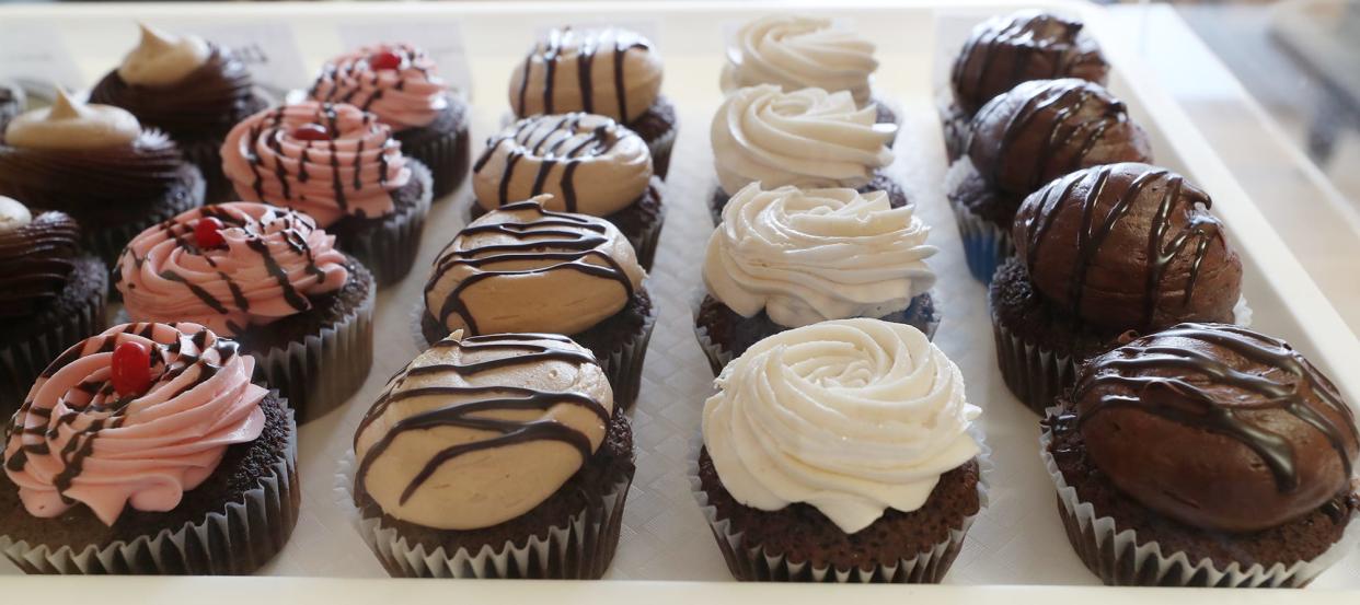 A tray of Pandora's Cupcakes, from left, Chocolate covered Strawberry, Peanut Butter Fudge, Vanilla on Chocolate and Triple Chocolate at Crafty Steere in Fairlawn on Friday, March 15, 2024.